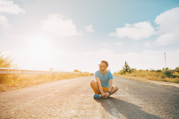 Young man smiling and enjoying sunny summer day