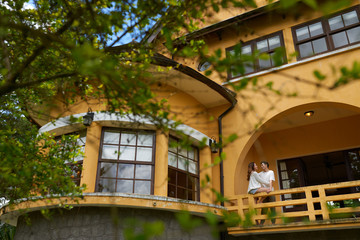 Young couple enjoying each others company on balcony of resort hotel