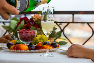Pouring champagne into glass at hen-party, close up