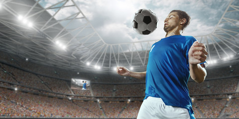 Soccer player performs an action play and beats the ball on a professional stadium. Player wears...