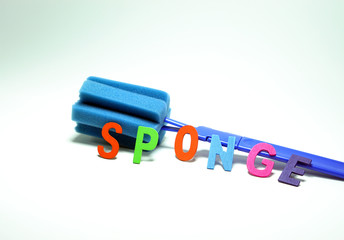 Bottle washing sponge with multicolor wood letter made SPONGE word isolated on white background