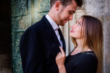 Woman looks in man's eyes hugging him tender