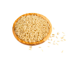 brown rice in a olive wood bowl isolated on white