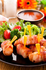Fried sausages and vegetables with sauce.