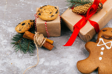 Christmas gingerbreads and cookies lie before a present box