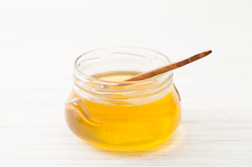 The Bank of floral honey on the white table