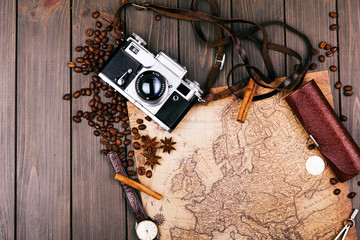 Old yellow map, glasses, coins, leather case, camera, watch, compasses, coffee beans, other spices...