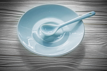 Coffee saucer spoon on vintage wooden board