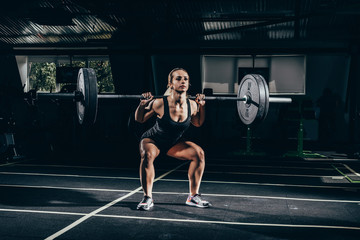 sportswoman lifting barbell