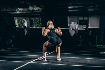 Obraz na płótnie Canvas sportswoman lifting barbell