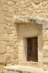 Naklejka premium Window on stone house in Pals, Girona, Spain