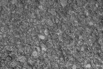 granite texture has a gray tint. a fragment of stone boulder closeup.