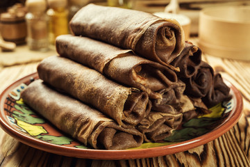 Stack of chocolate pancakes,Breakfast,snacks.Pancakes Day.Stack of kefir (buttermilk)chocolate pancakes,Pancakes with curd and raisins,Food photography.Breakfast for the whole family.With copy space