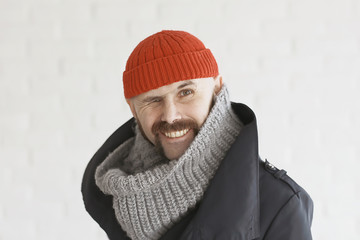 Fototapeta na wymiar guy with a mustache in a red knitted hat