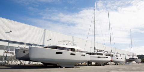 sailboat manufacturing dock in summer sun with cloud