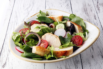 Chicken salad with leaf vegetables and cherry tomatoes.