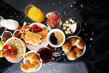 Breakfast served with coffee, orange juice, croissants and strawberry, jam and tea.