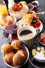 Breakfast served with coffee, orange juice, croissants and strawberry, jam and tea.