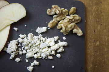 Close up of blue cheese crumbles with apples and walnuts