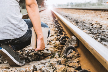 Woman wear jeans and sneaker shoes walk on the train railway,