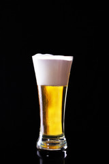 Glass of beer on black
