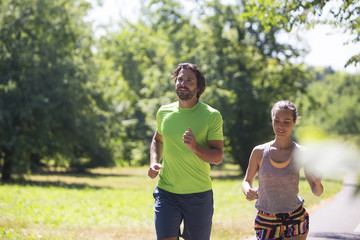 Healthy, fit and  sportive couple running in park