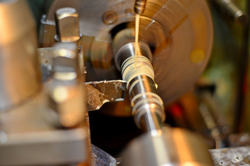 Professional machinist. Horizontal shot of a man operating lathe grinding machine metalworking industry concept copyspace