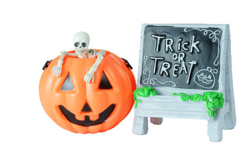 Halloween concept : Plastic human skeleton model  inside plastic Halloween Pumpkin buckets and Trick or Treat sign isolated on white background
