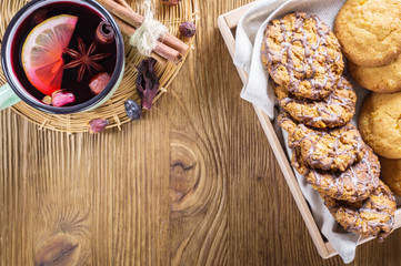 Hot cup of fruit tea and chocolate chips cookies.