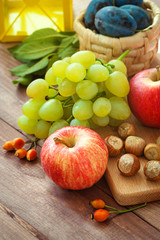 Naklejka na ściany i meble Fresh organic seasonal fruit, autumn fruit, nuts - autumn harvest on rustic table