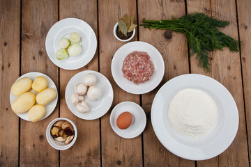 ingredients for cooking traditional dish pancakes with meat, potatoes, meat, mushrooms, mushrooms, egg