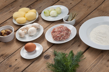 ingredients for cooking traditional dish pancakes with meat, potatoes, meat, mushrooms, mushrooms, egg