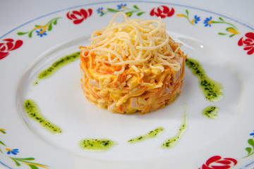 simple dish of Russian, Belarusian, Ukrainian cuisine on a white background, salad with carrots and cheese