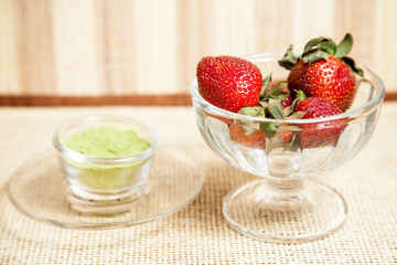 strawberry in the glass bowl on the table 