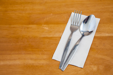 Cutlery spoon fork on the wood table in resturant