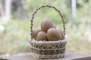 Eggs in a wicker basket On blurred background
