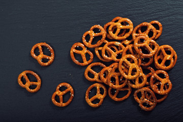 Food snack Salted crispy Pretzel on black slate plate with copy space