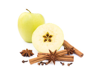 Apple, star anise, cloves and cinnamon isolated on white background