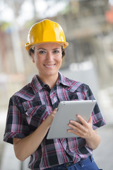 female construction engineer working on laptop at site