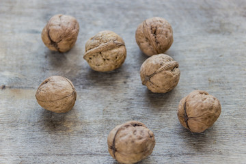 Walnuts on wooden table. Whole fresh walnuts