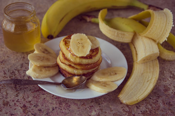 Pancakes with bananas and honey. Homemade breakfast