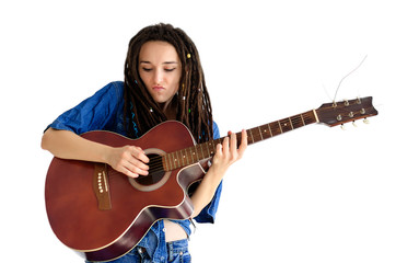 Girl with dreadlocks in a blue shirt with a classic acoustic guitar jumbo on a white background....