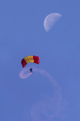 Military, descending in parachutes, with the moon in the background. Spain