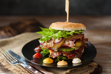 Fresh grilled beef burger on rustic wooden table