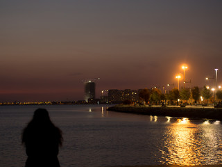 Fototapeta na wymiar girl sitting by the sea