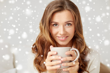 close up of happy woman with coffee cup at home