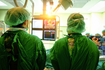 surgeon doctor with coronary monitor.