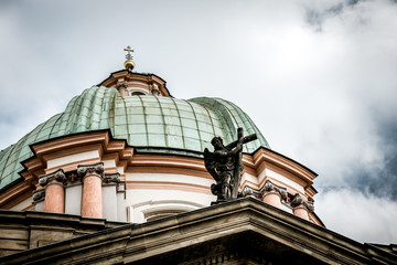 Fototapeta na wymiar Dome of the ancient church in Prague and the dark stormy sky