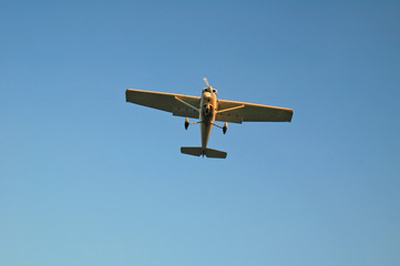 small white single engine passenger plane just before landing