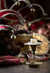 Candlestick and carnival masks .